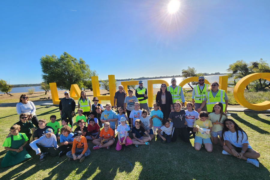 Niños junto a letras pintadas de amarillo